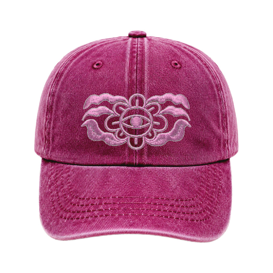 Deep magenta cap with a pale pink embroidered flower with an eye at its centre