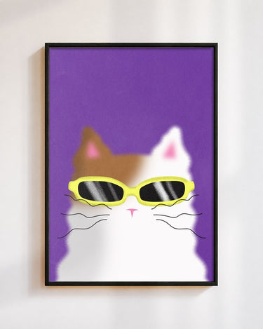 Cool Cat poster in a black frame on a white wall: a calico cat in yellow sunglasses on a violet background