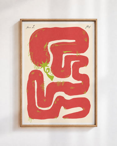 Felfela poster in red, in a wooden frame on a white wall: a red chilli pepper looping into a maze on cream