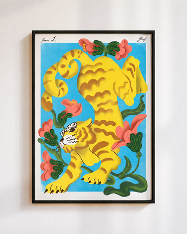 Garden Tiger poster in blue, in a black frame on a white wall: a yellow striped tiger among coral flowers on a sky blue background