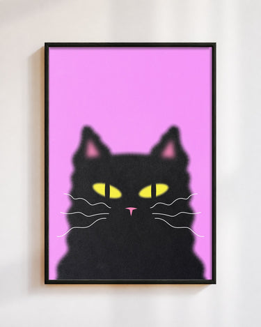 Midnight Cat poster in a black frame on a white wall: a fluffy black cat with yellow eyes on a hot pink background