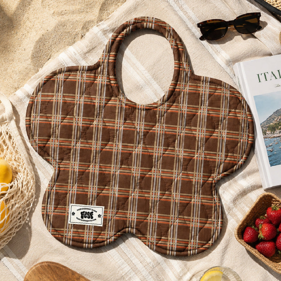 The cocoa check bag on a beach towel with sunglasses