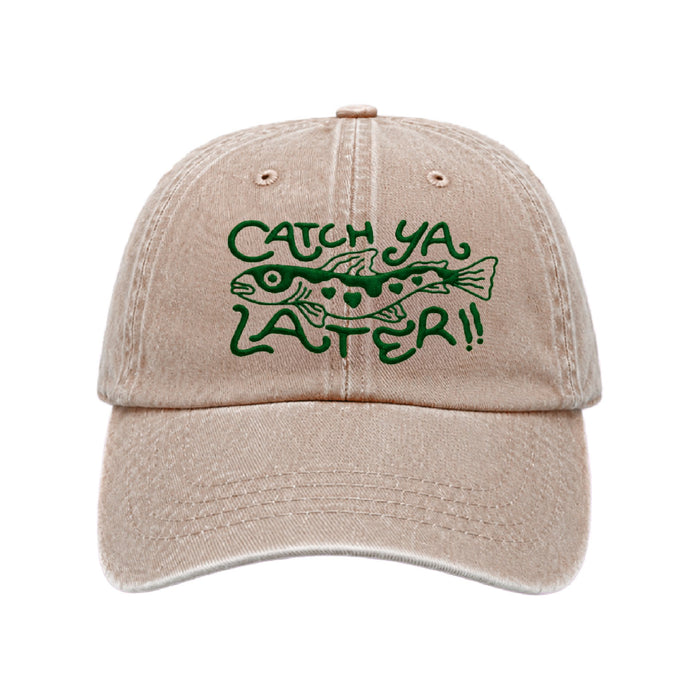 Sand coloured cap with CATCH YA LATER and a fish embroidered in dark green