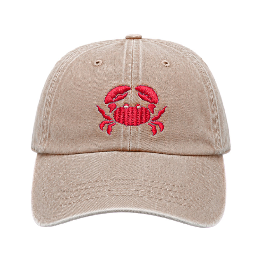 Sand coloured cap with a red crab embroidered on the front