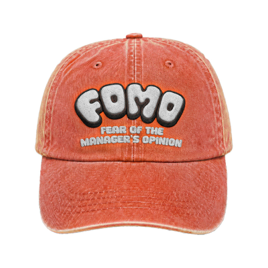 Terracotta cap with FOMO in white puff embroidery and fear of the manager's opinion beneath it