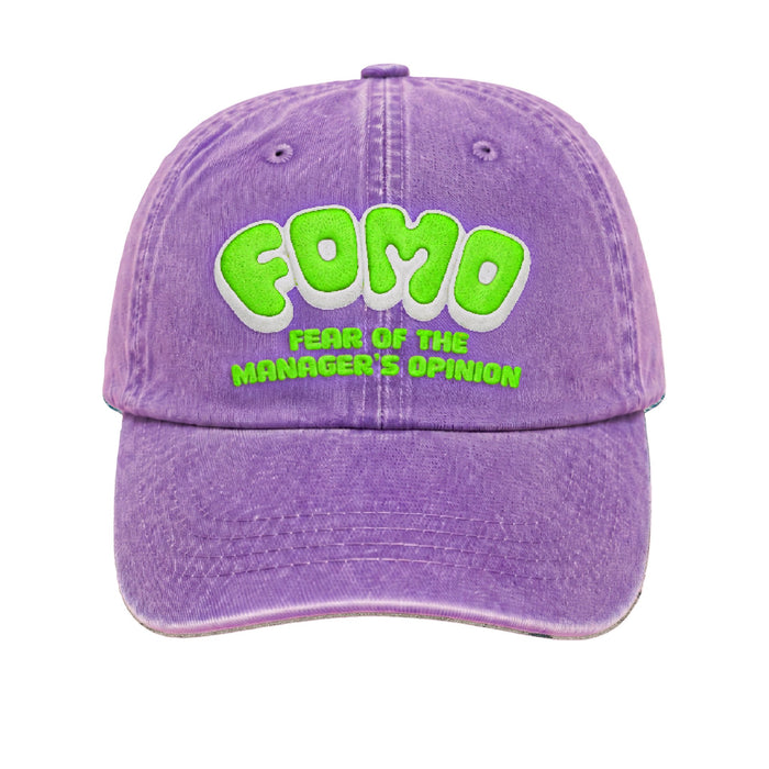 Washed purple cap with FOMO in green puff embroidery and fear of the manager's opinion beneath it