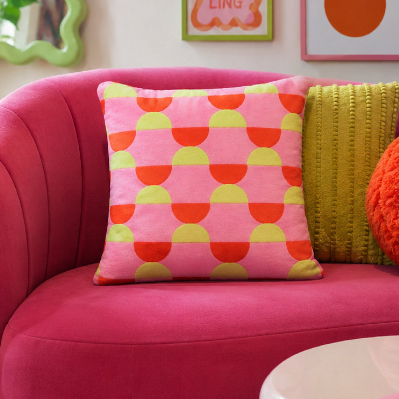 Sorbet Scallop cushion on a pink sofa