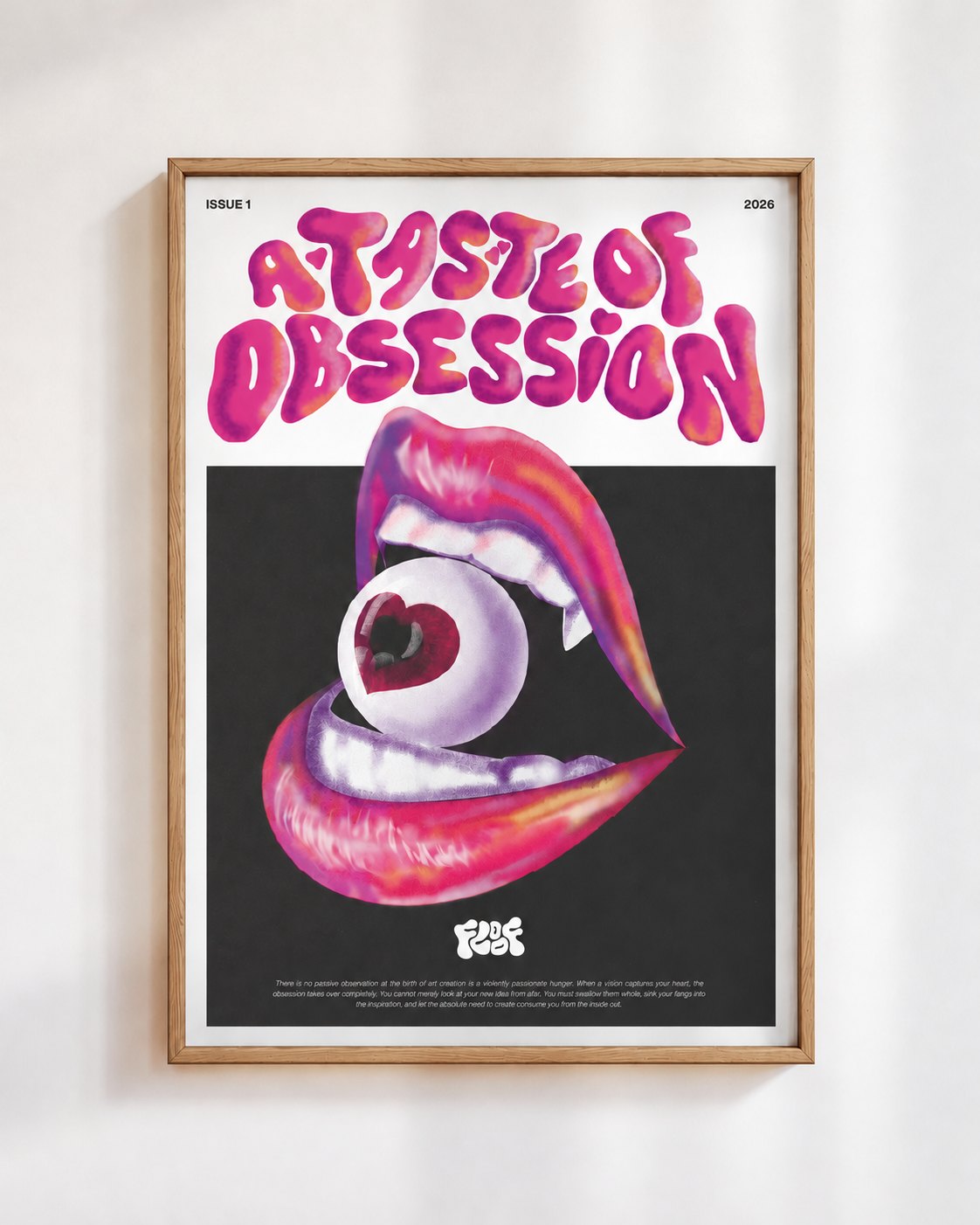 A Taste of Obsession poster in a wooden frame on a white wall: glossy pink lips biting an eyeball with a heart shaped pupil, under the words A Taste of Obsession